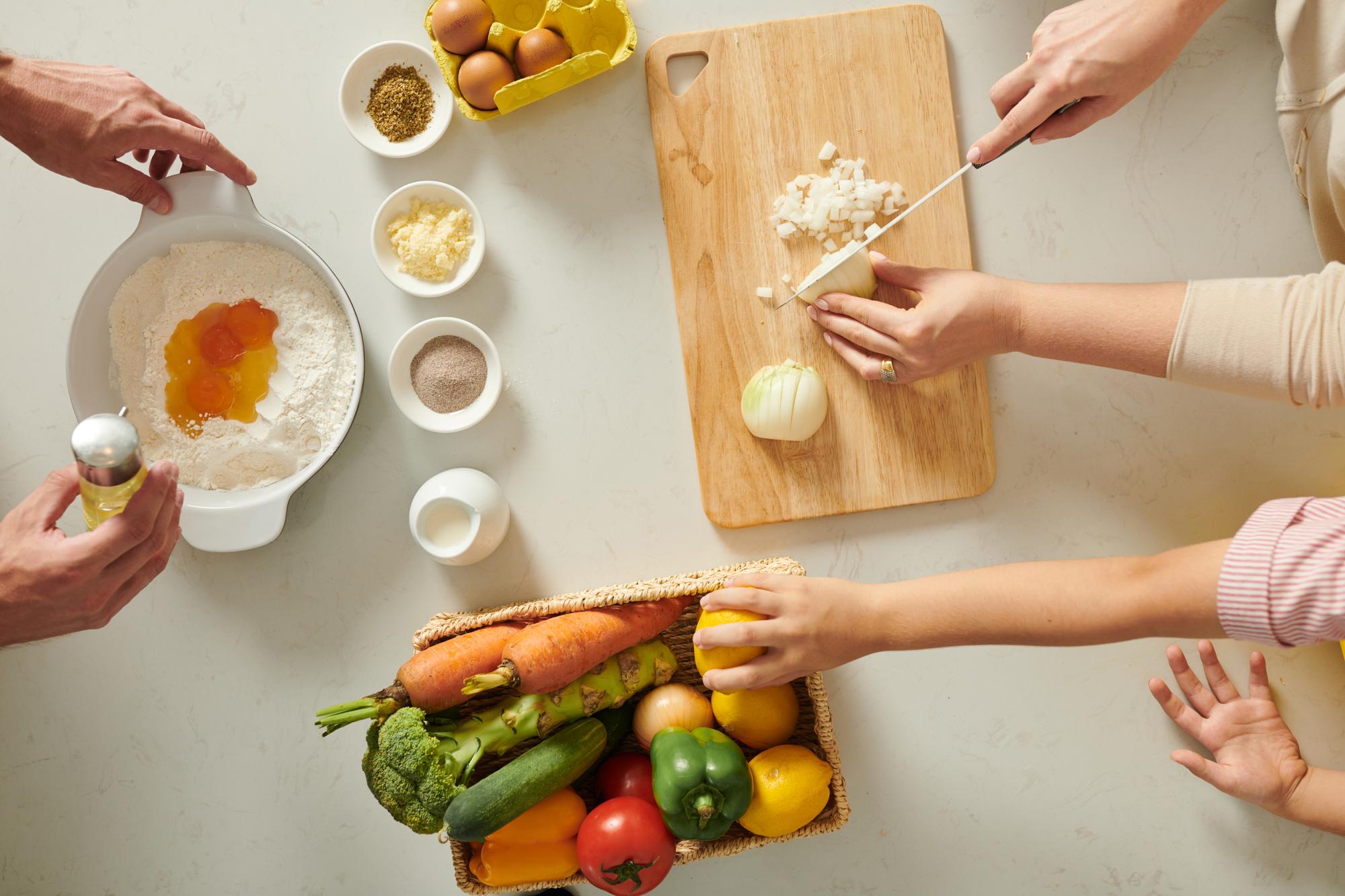 Hands preparing a simple meal kit on a light counter